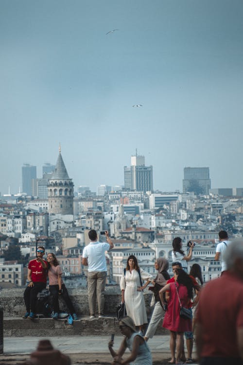 People Standing in Istanbul with Galata Tower and Cityscape behind