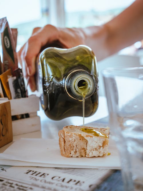 Pouring Olive Oil on Bread