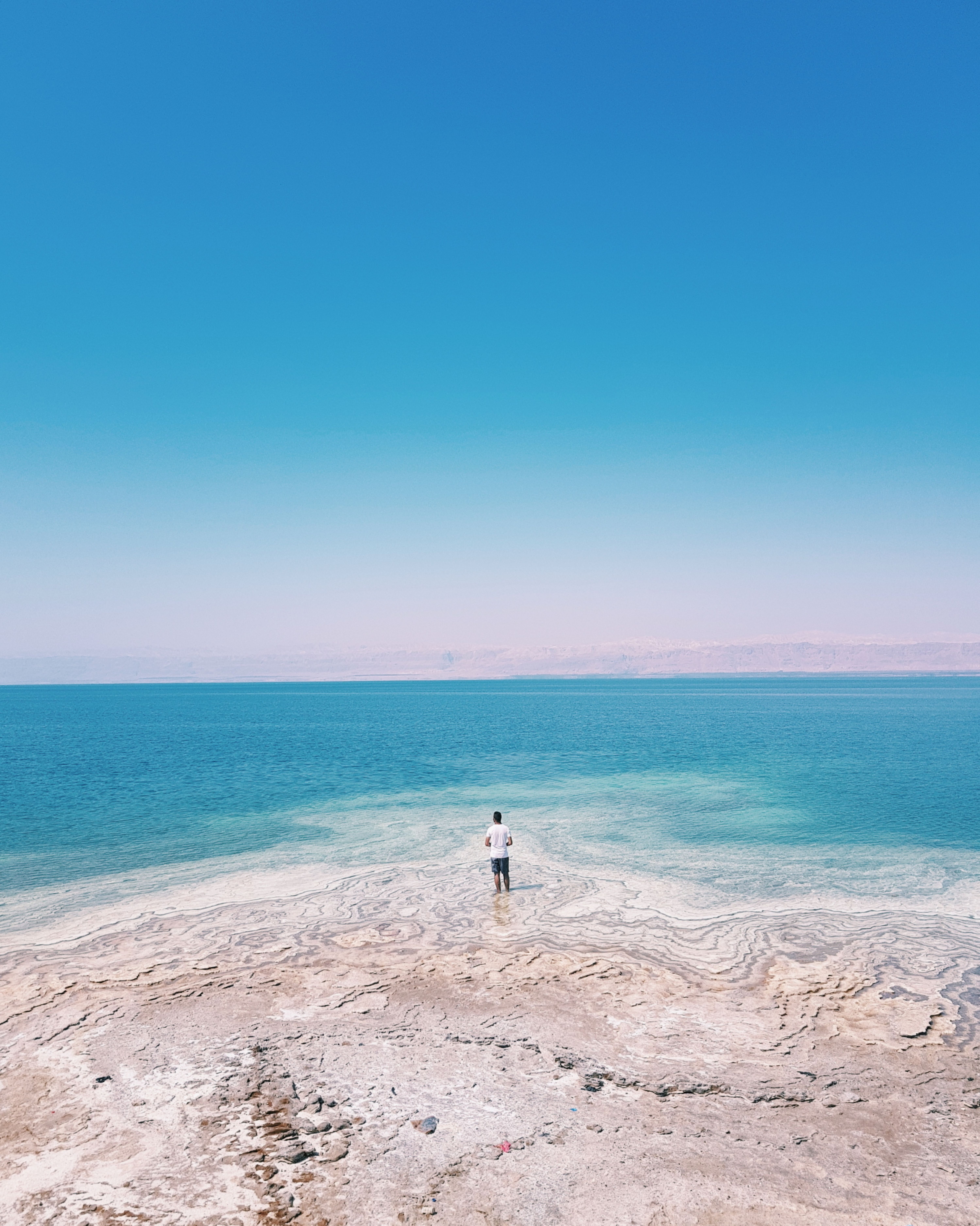 Man standing on eroded seashore, Djibouti