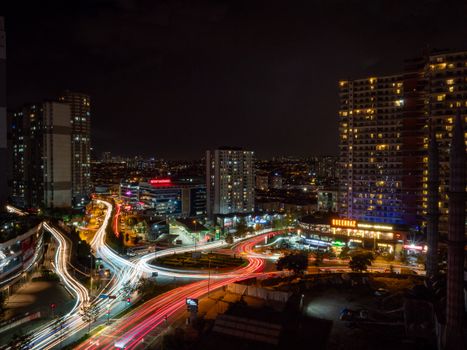 Aerial view of Istanbul's illuminated cityscape at night, showcasing sprawling streets and high-rise buildings.