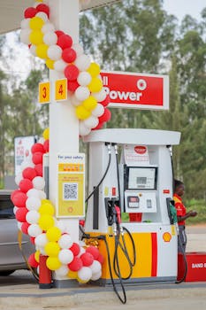 A festive fuel station adorned with red, white, and yellow balloons, offering a welcoming atmosphere.