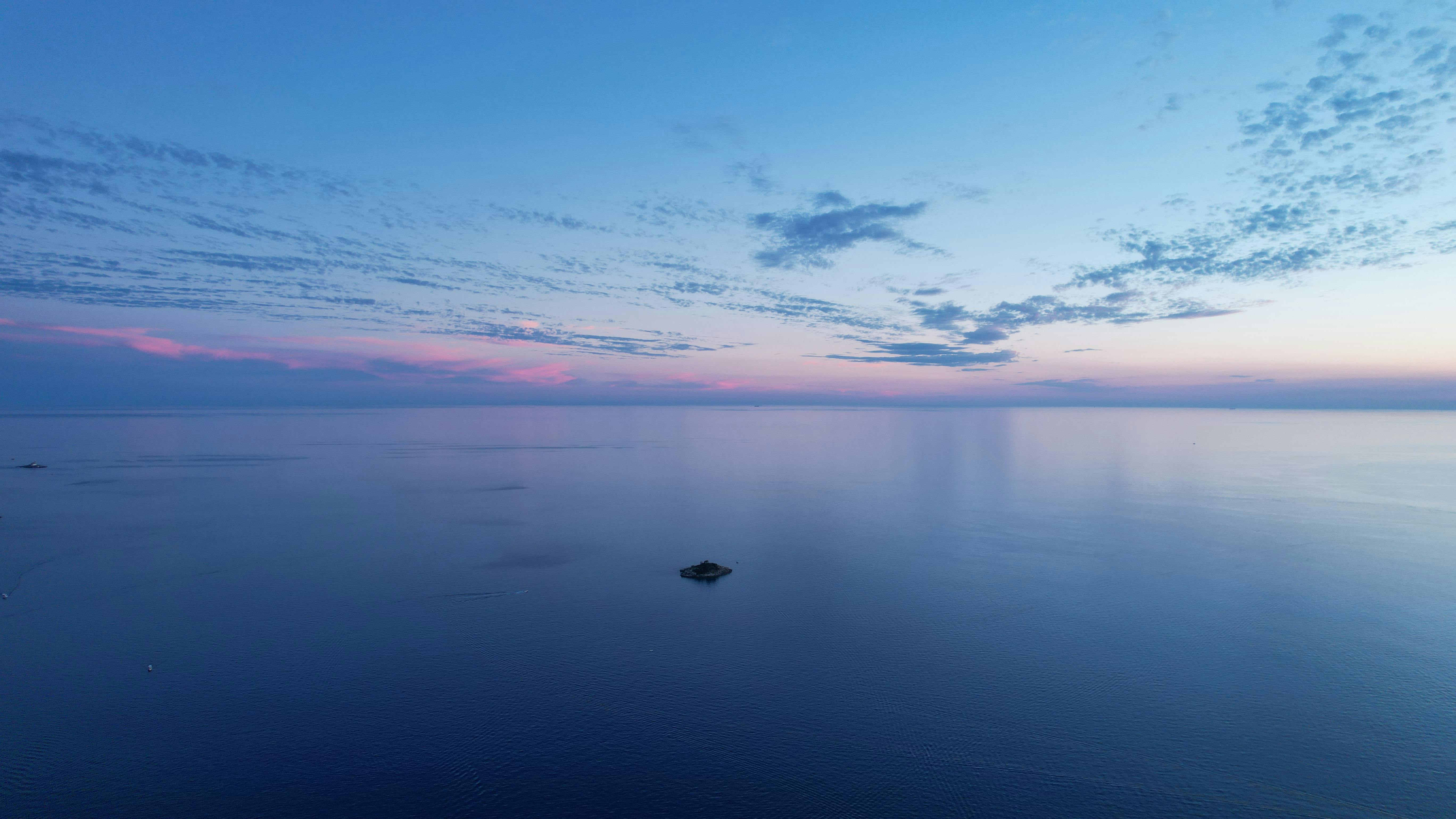 Mediterranean sea horizon with calm water and sunset clouds