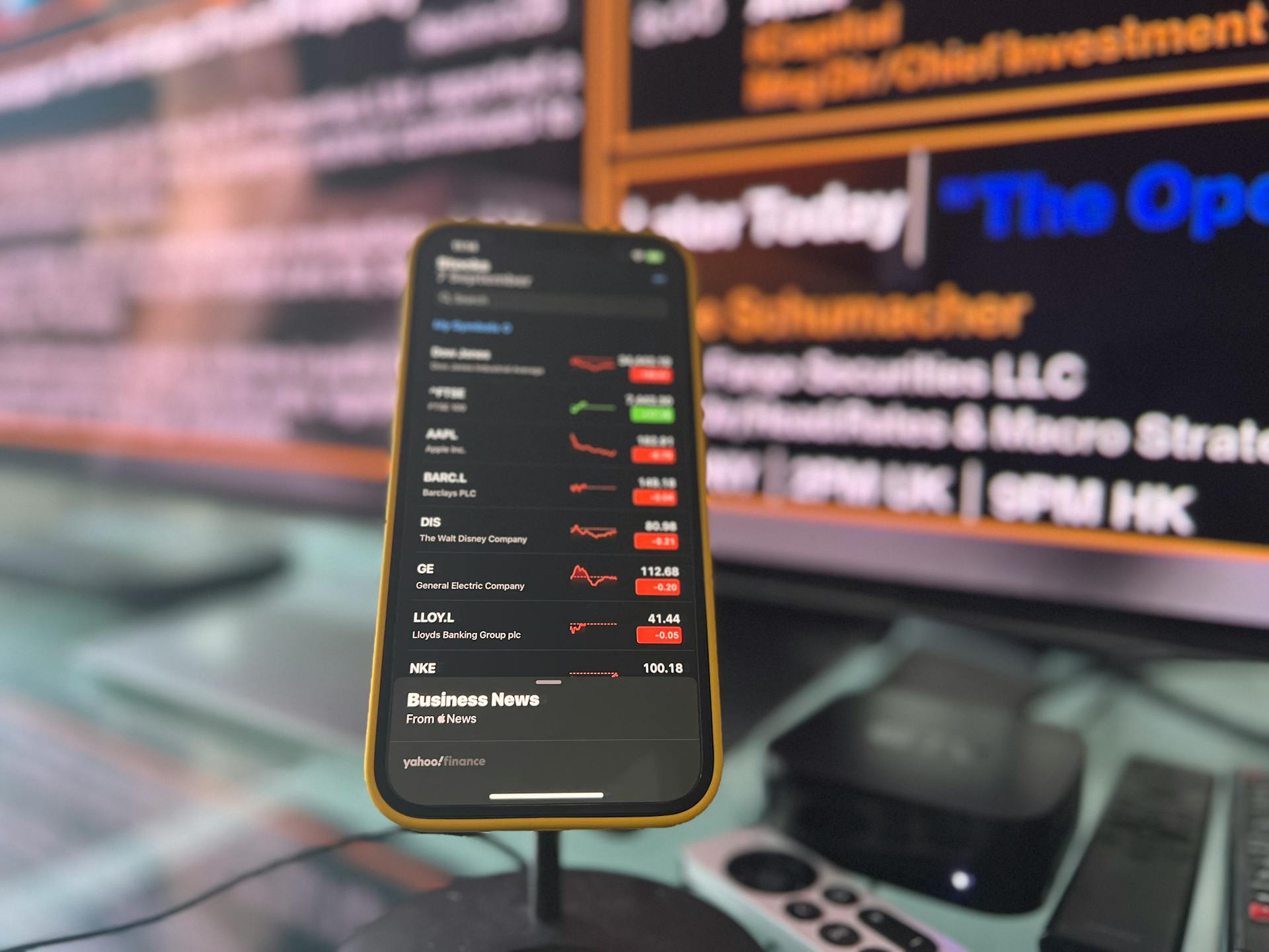 Smartphone on a Stand with Stock Market Data on the Screen