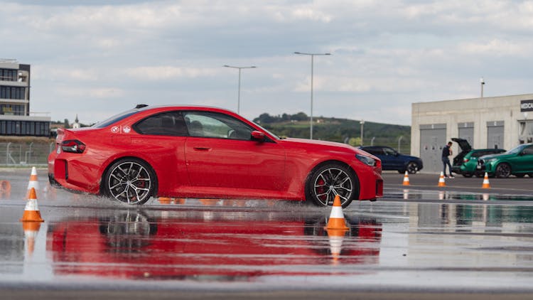 Red BMW M2 In Training On Wet Circuit