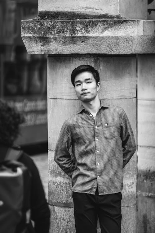 Portrait of Man in Shirt Standing by Wall