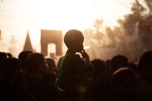 Back View of a Silhouetted Crowd at Sunset