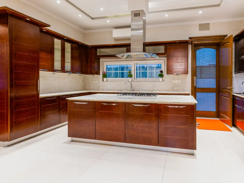 Luxury kitchen with dark wood cabinets and marble countertops Luxury kitchen with dark wood cabinets and marble countertops