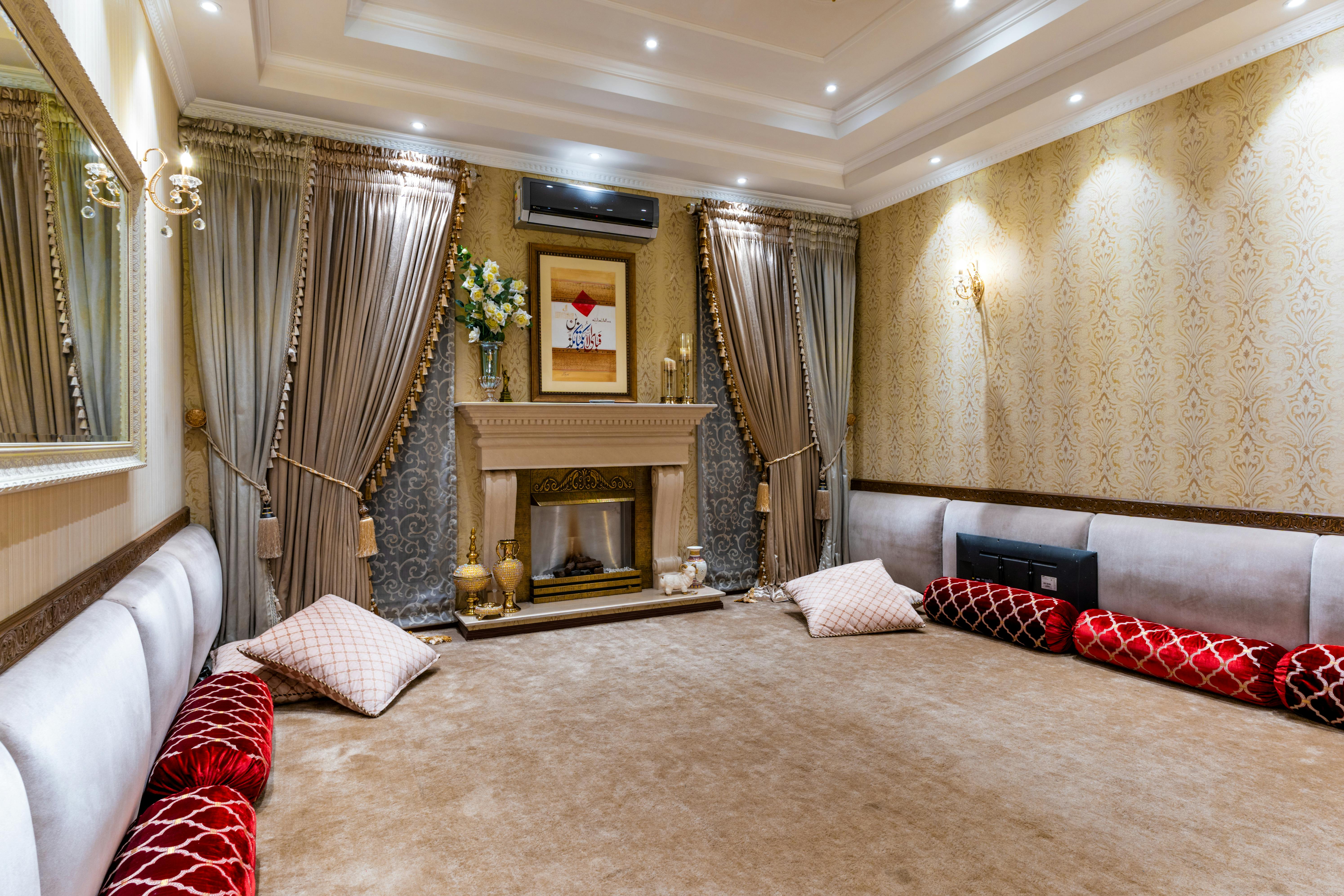 Luxurious traditional living room with ornate fireplace and plush cushions, showcasing cultural elegance.