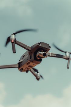 Close-up view of a sophisticated drone flying under a clear blue sky in Colombia.