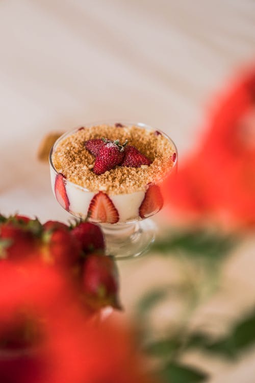 Dessert of Whipped Cream and Strawberries Sprinkled with Crushed Biscuits