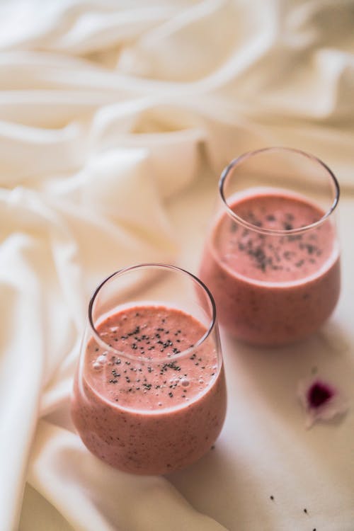 Glasses of Strawberry Smoothie with Pansy Seeds