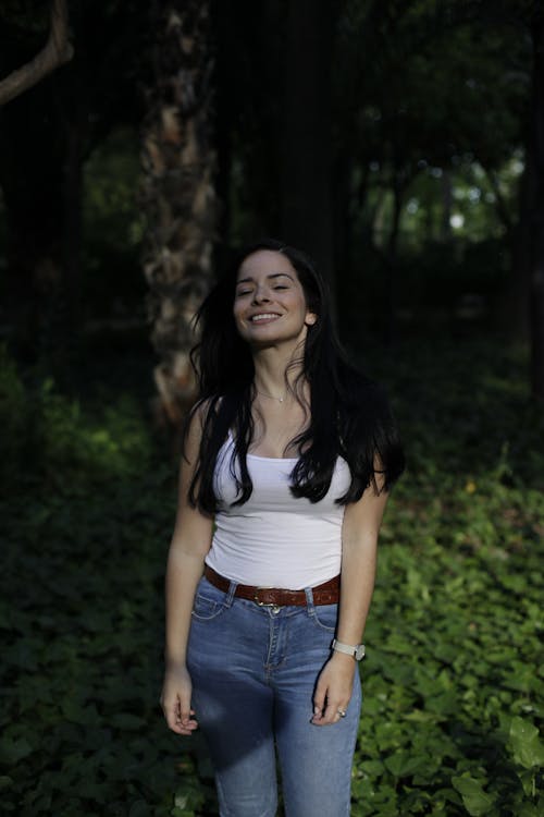 Smiling Woman with Black Hair in Forest
