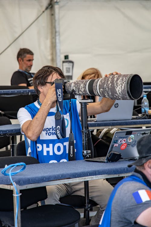 Man Holding Camera with Zoom Lens