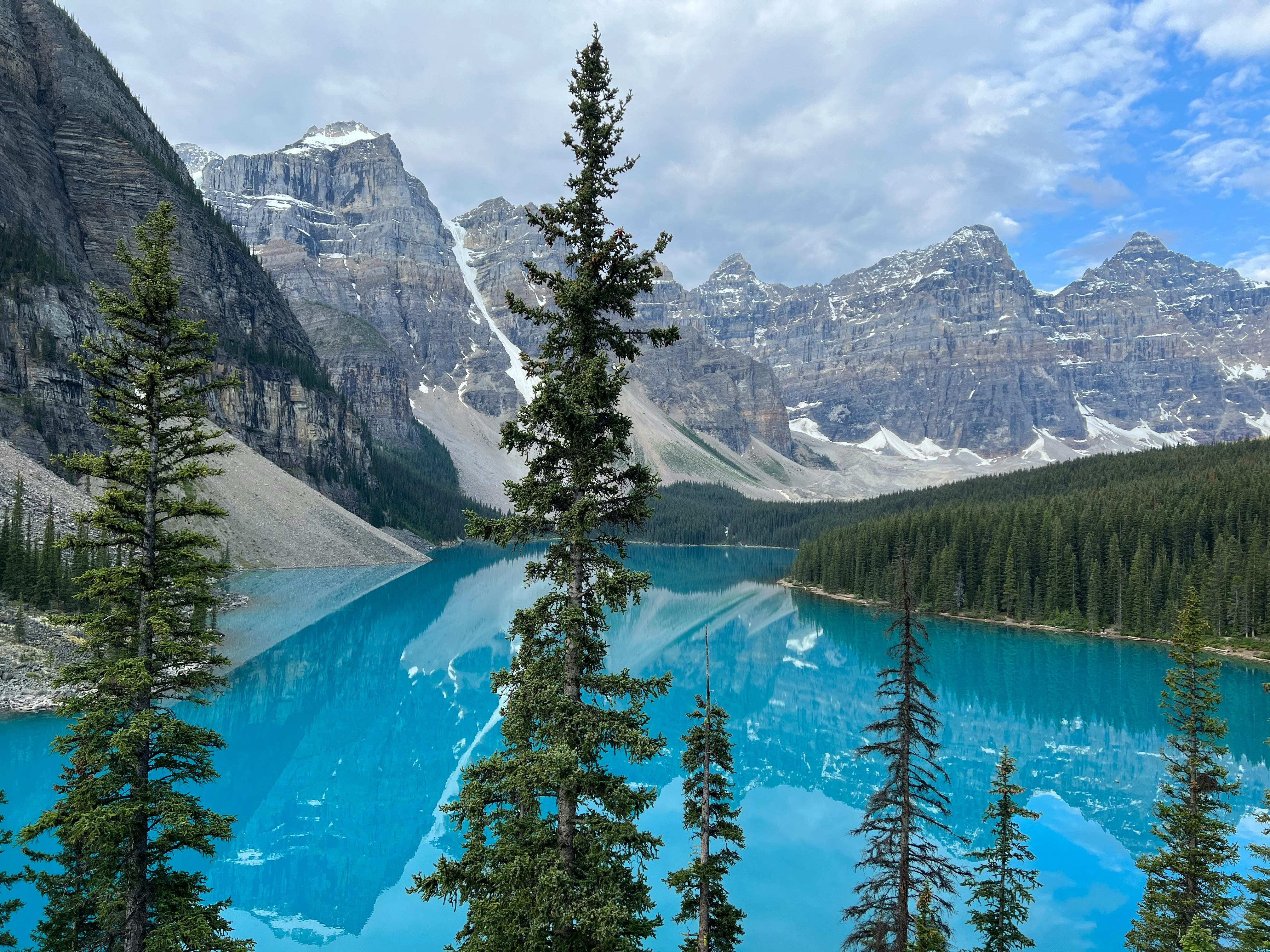 Scenic view of Moraine Lake's turquoise waters and the surrounding Canadian Rockies in Banff National Park.