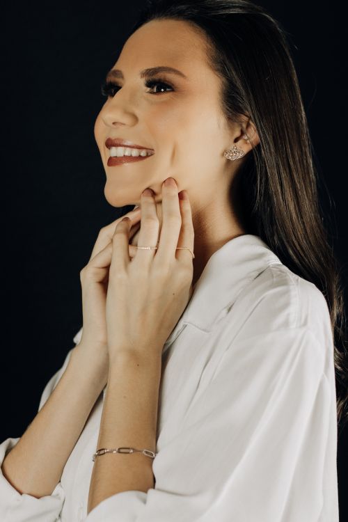 Free Elegant fashion portrait of a smiling woman with long hair against a black background. Stock Photo