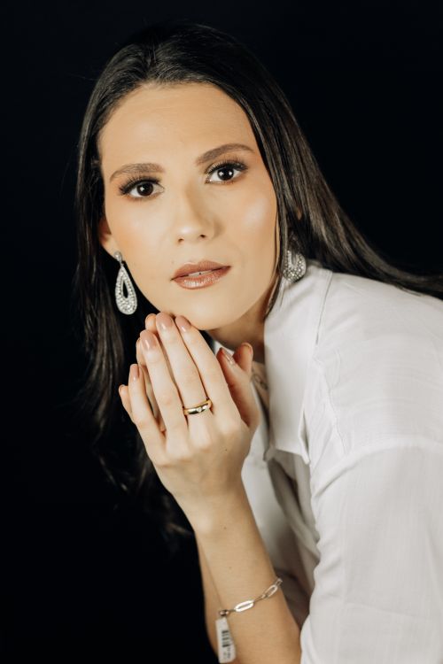 Free Portrait of an elegant woman with jewelry against a dark background, exuding sophistication. Stock Photo