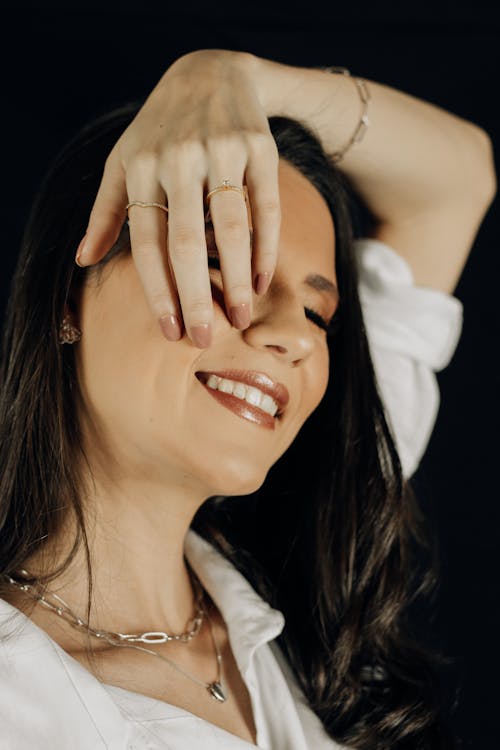 Smiling Woman with Hand on Face