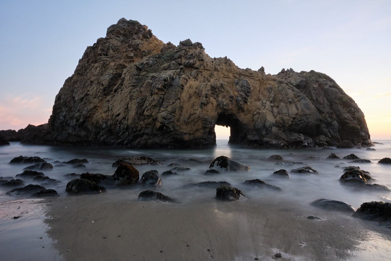 long exposure of iconic keyhole rock at pfeiffer beach during sunset u