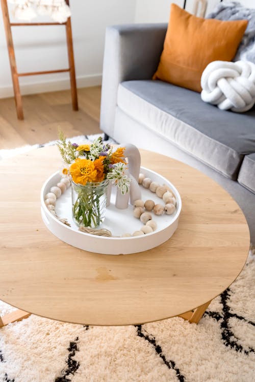 A Decoration with Flowers on the Coffee Table in a Room