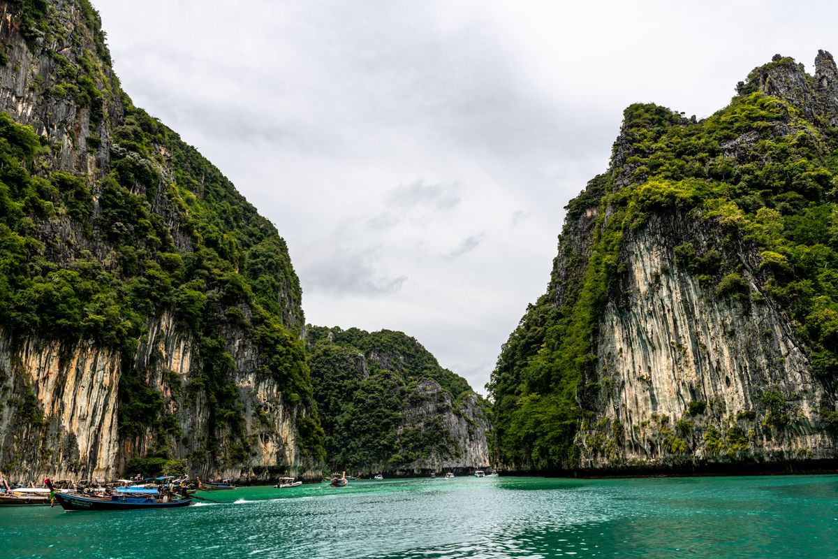 Emerald-green lagoon surrounded by limestone cliffs in Thailand, similar to Ang Thong's famous Emerald Lagoon