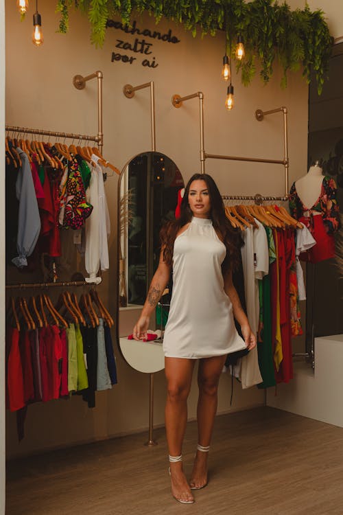 Brunette Woman in White Dress in Clothing Store