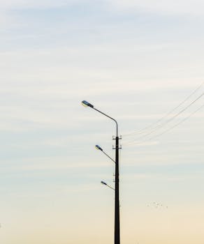 A minimalist street lamp silhouette against a serene sky at dawn in Vitebsk, Belarus.