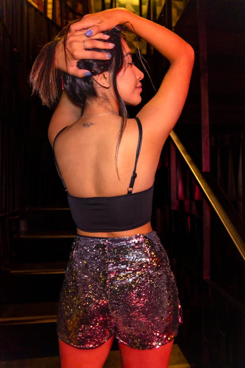 Woman Wearing Glitter Shorts in a Club 