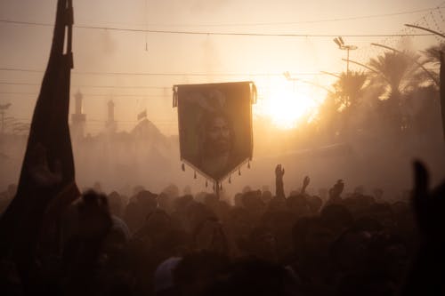 A Crowd Walking in a Parade at Sunset