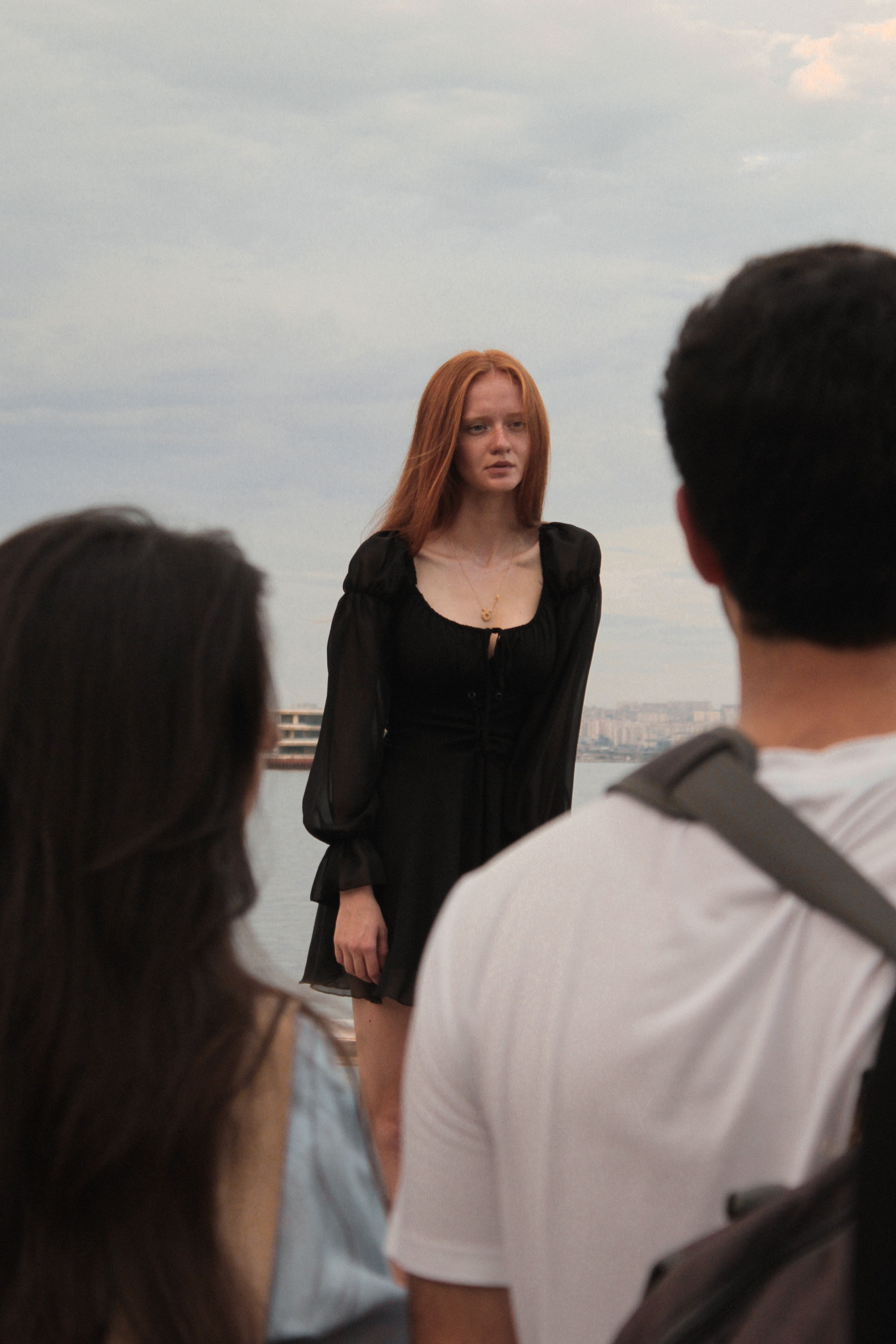Woman in a Black Dress Standing on a Beach · Free Stock Photo