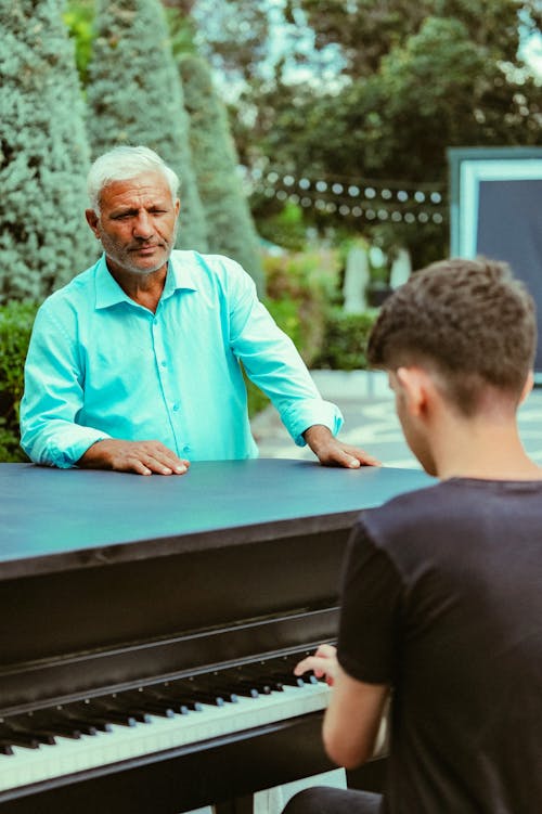 Man Look at Man Playing Piano 