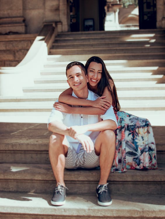 Woman Hugging Man on Stairs