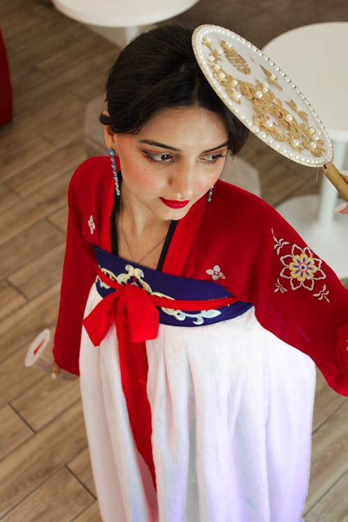 Woman in Traditional Clothing and with Fan