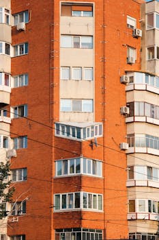 Brick facade of a modern apartment building in Timișoara, Romania, showcasing urban architecture.
