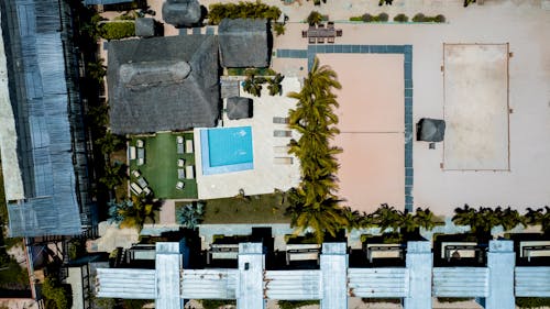 Drone Photo of a Tropical Resort Yard with a Pool