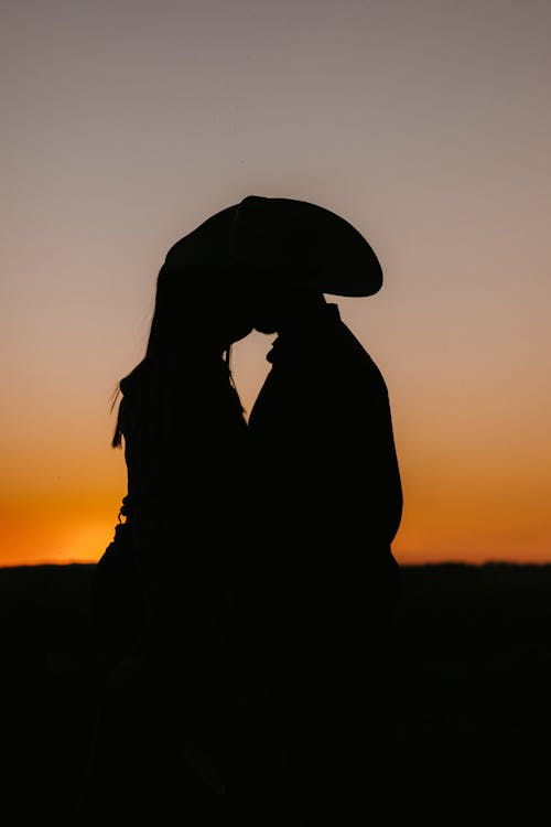 Free stock photo of couple, couple hugging, cowboy hat