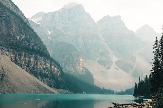 Explore the tranquility of Moraine Lake in Banff's rugged wilderness with majestic mountains and serene waters.