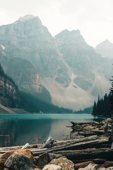 Majestic view of a tranquil lake surrounded by towering mountains and lush forests in Banff National Park.