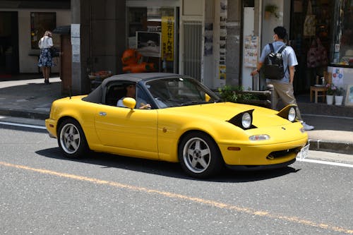 Yellow Mazda on a Street 