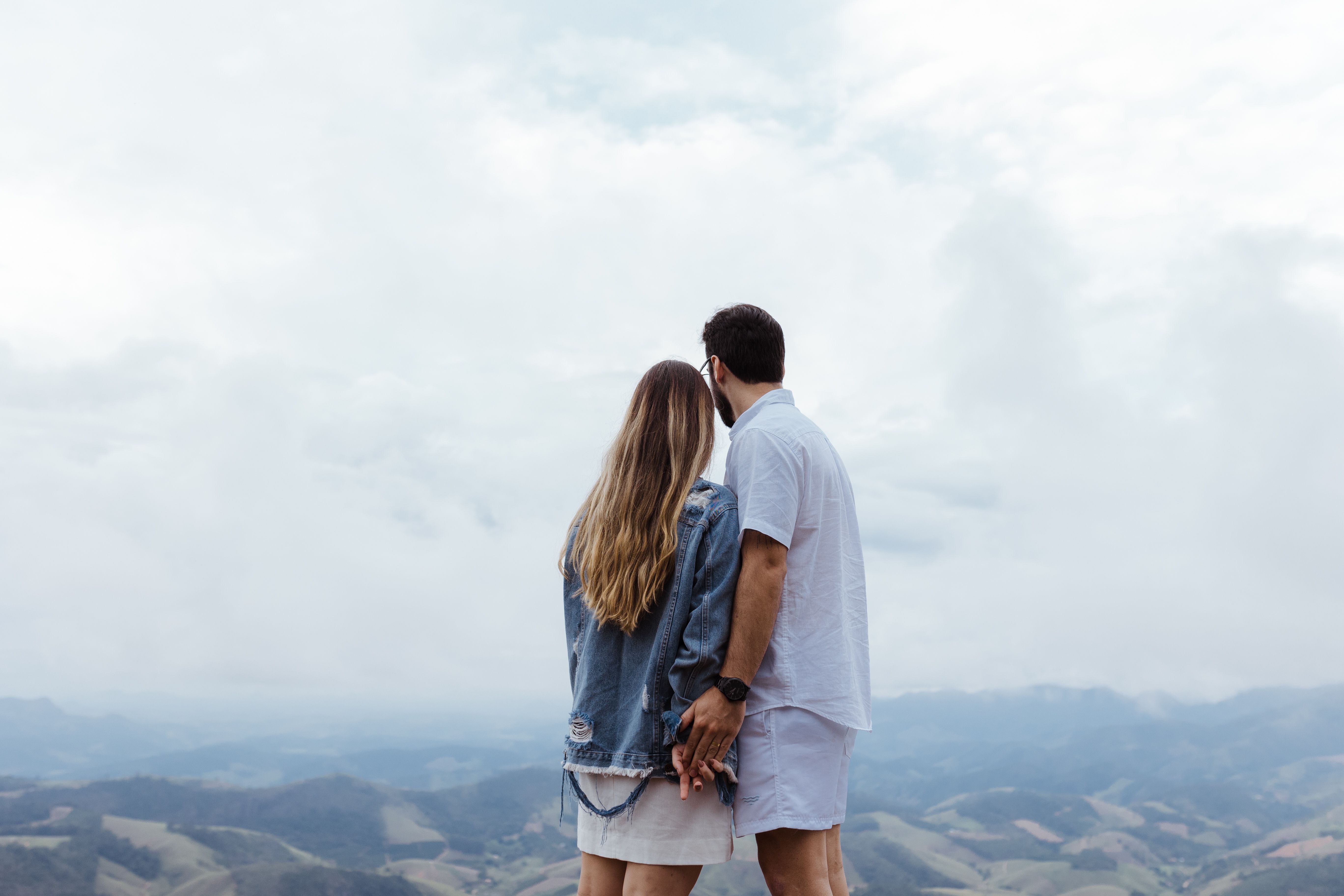 Cute Couple Standing Together in the Mountains · Free Stock Photo