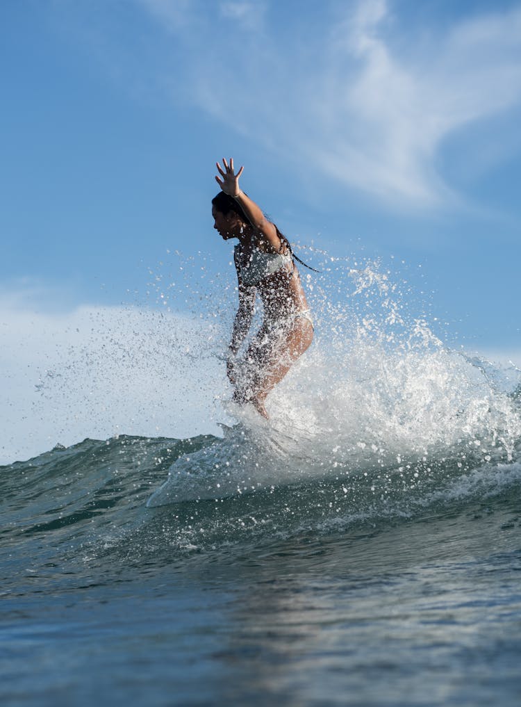 Woman Surfing On Wave