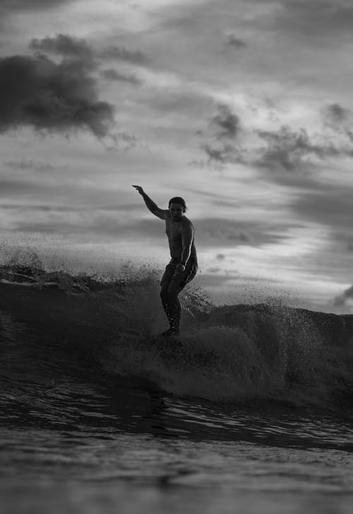 Man Surfing on Ocean Wave