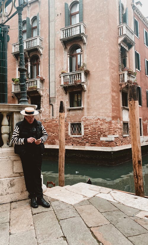 Gondolier by Canal in Venice