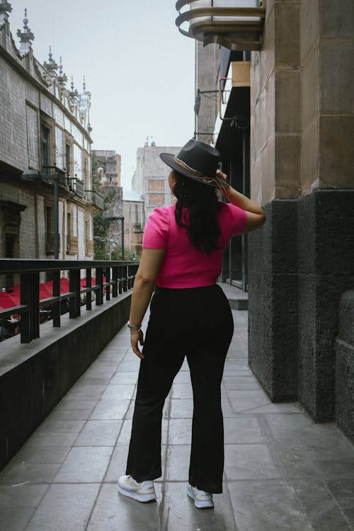 Brunette Woman in Pink T-Shirt and Black Pants