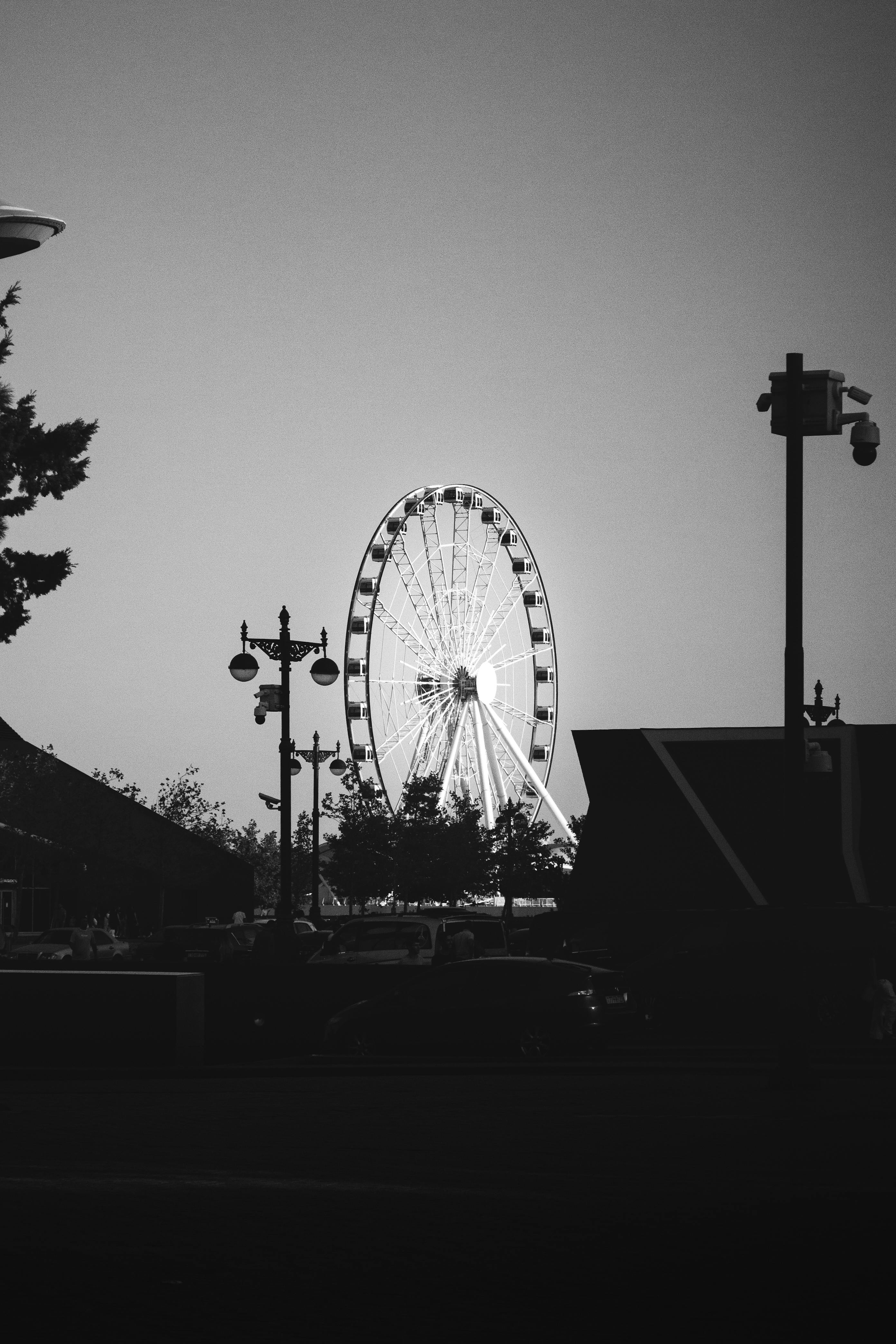 Black and white photo of a ferris wheel in Baku, Azerbaijan at dusk.