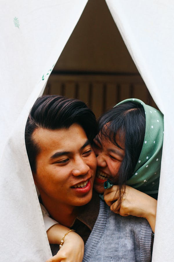 Woman Hugging Man in Gray Sweater
