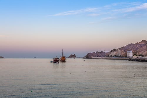 Sailboats on the Sea near the Shore with Hills