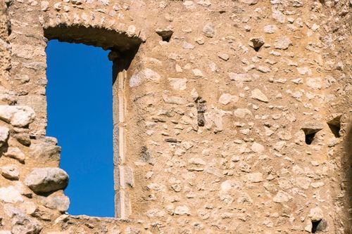 Free Close-up of a historic stone wall ruin with window in Miglos, France. Stock Photo