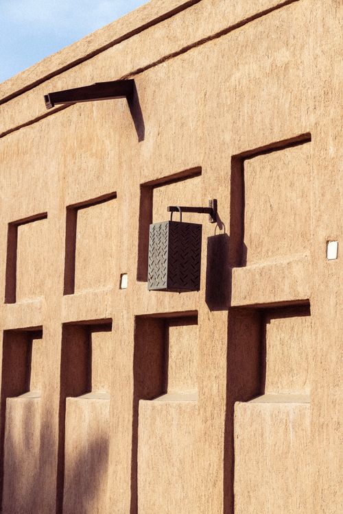 Free Close-up of traditional architecture wall with decorative lamp in Dubai, showcasing geometric design. Stock Photo
