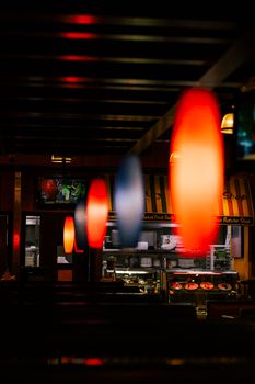 Moody interior of a Dubai restaurant with colorful hanging lights creating a warm ambiance.
