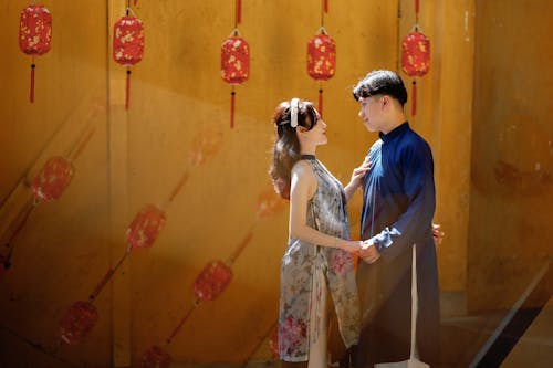 Couple Holding Hands under Red Paper Lanterns